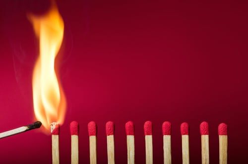 Stock photo image of a line of matches catching on fire.