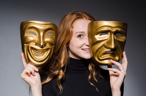 Redheaded woman with theater masks of tragedy and comedy.