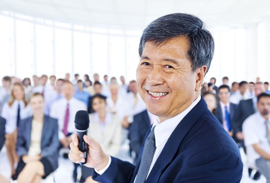 Stock photo of Asian businessman speaking at a conference on leadership.