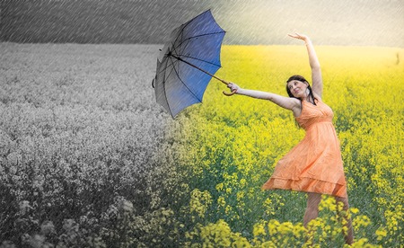 Woman with umbrella demonstrating how to use positive visualization.