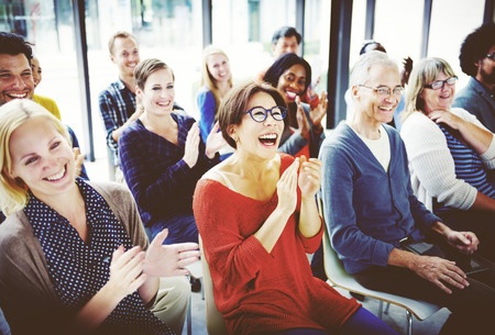 Stock photo of audience applauding and enjoying a performance.