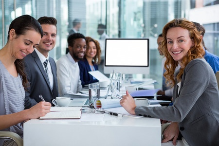 Photo of happy business people during video conference or teleconference.