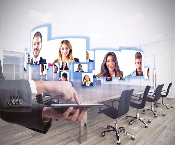 Photo of happy employees at videoconference or teleconference demonstrating telepresence.