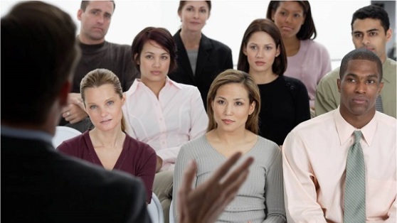 Stock photo of audience listening to a business presentation.