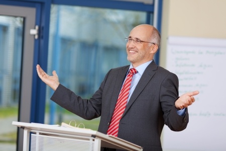 Stock photo of businessman using body language while giving a speech.