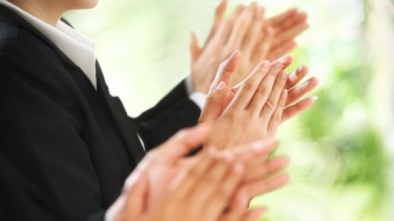 Stock photo of applause at a business conference. How to introduce yourself in a business meeting matters greatly to career success.