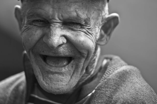 Stock photo of old man laughing.