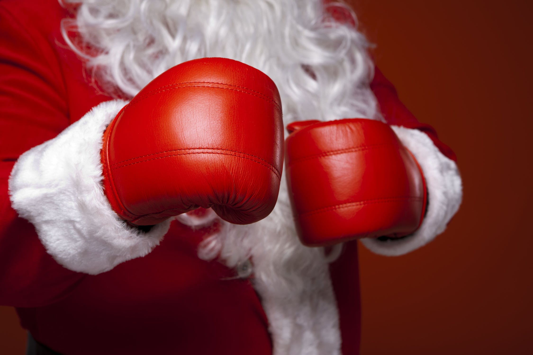Stock photo of Santa Claus with boxing gloves.