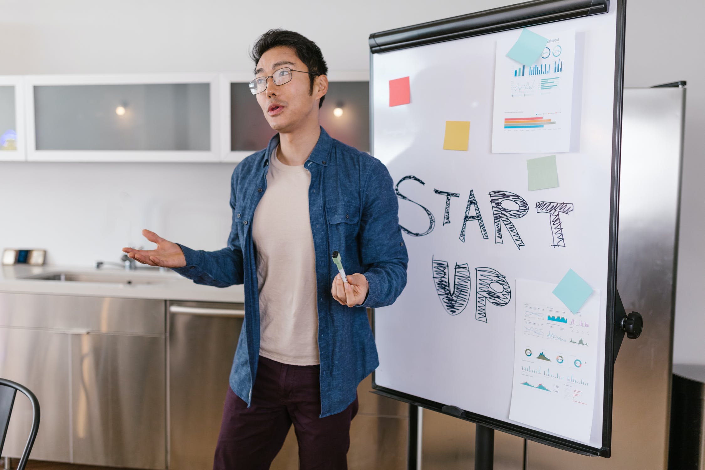 Stock photo of Asian-American male delivering a business presentation.