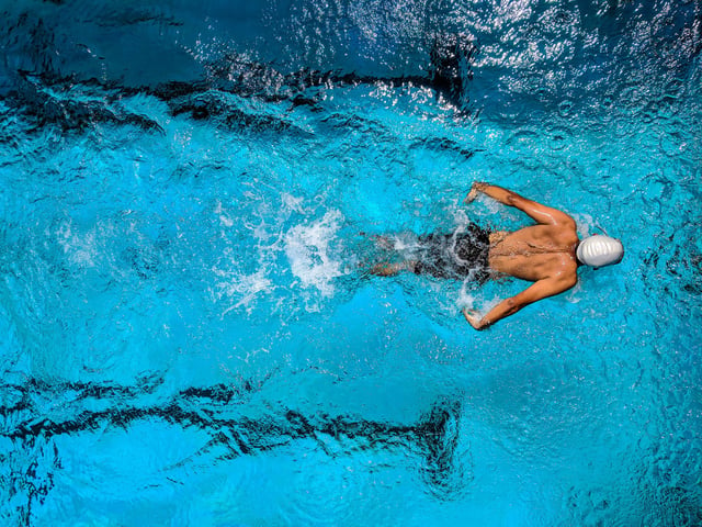 Stock photo of competitor swimmer in pool.