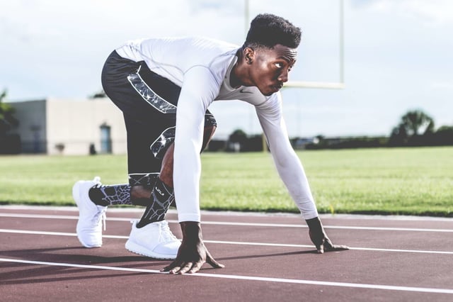 Stock photo of African American athlete at the starting line of a race.