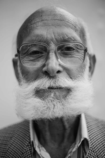 Stock photo of elderly man with full beard.